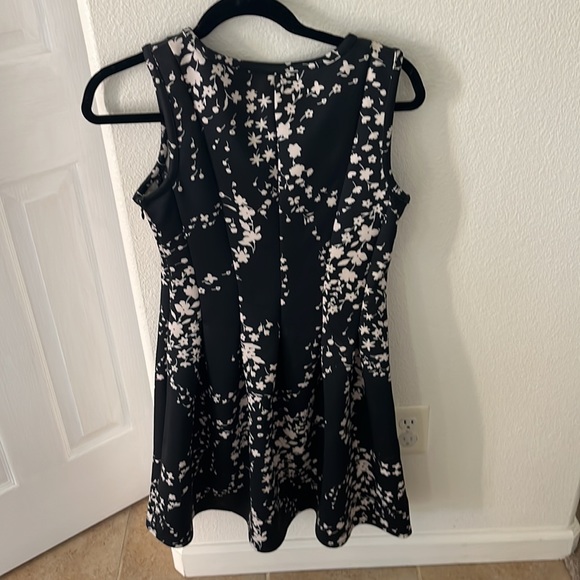 Short, pleated, form fitted at top, flared at the bottom. - Picture 3 of 6